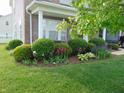 Landscaped front garden with flowering plants and manicured shrubs at 6836 Eagle Crossing Blvd, Brownsburg, IN 46112