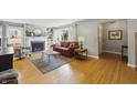 Bright living room with hardwood floors, fireplace, and large windows at 7060 N Park Ave, Indianapolis, IN 46220