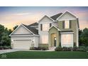 Charming two-story home with beige siding, a brick facade, and a manicured lawn at 7239 Barrett Dr, Brownsburg, IN 46112