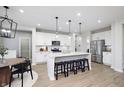 Modern kitchen features a large island, stainless steel appliances, and sleek, white cabinets at 7239 Barrett Dr, Brownsburg, IN 46112