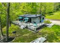 Charming home featuring an expansive deck, outdoor furniture, a swing, and mature trees, perfect for outdoor living at 7595 Heather Dr, Nineveh, IN 46164