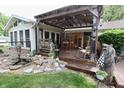 Inviting backyard deck with a covered seating area, a water feature, and lots of decorative touches at 76 Manhattan Ave, Indianapolis, IN 46241