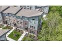 Aerial view of modern townhome showcasing brick and siding facade, professional landscaping, and inviting entrance at 8245 Bostic Dr, Fishers, IN 46038