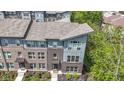 Aerial view of modern townhome showcasing brick and siding facade, professional landscaping, and inviting entrance at 8245 Bostic Dr, Fishers, IN 46038