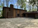 The large concrete driveway leads to a two-car garage with brick and siding exterior at 830 Millerwood Dr, Lebanon, IN 46052