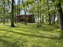 A two-story home is surrounded by lush greenery with mature trees at 830 Millerwood Dr, Lebanon, IN 46052