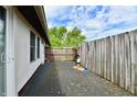 Exterior view of the back patio with a wooden fence and sliding glass doors at 8360 Paso Del Norte Ct, Indianapolis, IN 46227