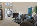 Inviting living room features a cozy fireplace, plush seating, and a soaring two-story ceiling for a spacious feel at 8644 S Tibbs Ave, Indianapolis, IN 46217