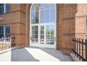 Exterior entrance featuring brick and a large arched window above double doors at 8751 Jaffa Court East Dr # Apt 32, Indianapolis, IN 46260