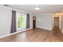 Bright living room with entry door and large windows with grey curtains at 916 S Outer Dr, Lebanon, IN 46052