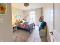 Cozy bedroom with bright decor, soft carpeting, and natural light from a large window at 9789 Rue Renee Ln, McCordsville, IN 46055