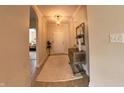 Inviting entryway with neutral walls, decorative table, and eye-catching rug at 9789 Rue Renee Ln, McCordsville, IN 46055