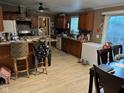 Eat-in kitchen with wood cabinets, updated appliances, and counter seating at 1000 E Willard St, Muncie, IN 47302