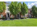 Well-maintained townhomes feature brick facade, manicured lawns, and mature shade trees at 1111 Cavendish Dr, Carmel, IN 46032