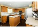 Functional kitchen featuring wooden cabinets, an island, and stainless steel appliances at 11727 Wedgeport Ln, Fishers, IN 46037