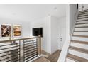 Open-concept living space with modern staircase and a comfortable seating area at 1216 N Alabama St, Indianapolis, IN 46202