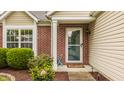 Charming front entrance with brick accents, a screen door, and landscaped garden at 12328 Slate Dr, Fishers, IN 46037