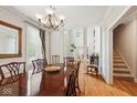 Elegant dining room showcasing a chandelier, hardwood floors, and classic furnishings at 13868 Broad Mdw, Carmel, IN 46032