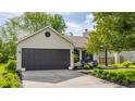 Exterior view of home featuring a garage, inviting front yard, and manicured landscaping at 14291 Holly Berry Cir, Fishers, IN 46038