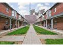 Brick courtyard between buildings featuring lush lawn and walking path at 1446 N Illinois St, Indianapolis, IN 46202