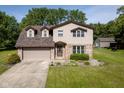 Lovely two-story home with a well-manicured lawn, an attached two-car garage, and mature trees in the backyard at 16226 Montrose Ln, Westfield, IN 46074