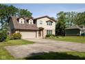 Attractive two-story home with a brick and siding exterior, complemented by a green lawn and a long driveway at 16226 Montrose Ln, Westfield, IN 46074