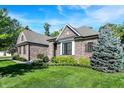 A well-manicured lawn and landscaping complement this brick home featuring a beautiful, mature blue spruce tree at 16890 Catkins Ct, Westfield, IN 46074