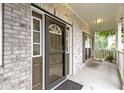 Inviting front porch with brick facade, complemented by a charming swing at 18711 Crestline Ct, Noblesville, IN 46060