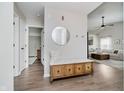 Inviting entryway with hardwood floors and stylish storage bench at 18760 Pilot Mills Dr, Noblesville, IN 46062