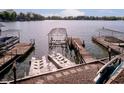 Lakefront view of multiple boat docks and boat lift, providing direct access to the water for boating and recreation at 1940 Stringtown Pike, Cicero, IN 46034