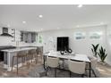 Bright open kitchen with stainless steel appliances, gray cabinetry, and a marble countertop island at 2302 S Pennsylvania St, Indianapolis, IN 46225