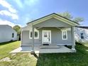 Cozy home showcasing covered front porch with a concrete base at 2417 Crystal St, Anderson, IN 46012