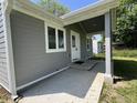 Exterior of a home with a covered porch and updated gray siding at 2417 Crystal St, Anderson, IN 46012