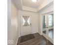 Bright entryway with hardwood floors, a white front door, and glass french doors at 2780 Cormorant Dr, Greenwood, IN 46143