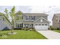 Charming two-story home with gray siding, attached two car garage, and a well manicured front yard at 2780 Cormorant Dr, Greenwood, IN 46143
