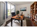 Bright office featuring a wood desk, large window, and built-in bookcase, perfect for a productive workspace at 2780 Cormorant Dr, Greenwood, IN 46143