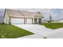 Inviting single-Gathering home with a spacious driveway, a two-car garage, and a beautifully landscaped front yard at 3622 S Setting Sun Ln, New Palestine, IN 46163
