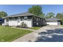 View of home's exterior, featuring a detached garage, and long driveway at 370 N Bazil Ave, Indianapolis, IN 46219
