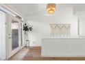 Bright entryway featuring hardwood floors, a stylish light fixture, and a decorative macrame wall hanging at 3781 S Station Dr, Columbus, IN 47203
