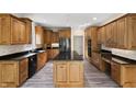 A spacious kitchen featuring custom wood cabinetry, granite countertops, and stainless steel appliances at 4139 Bayberry Ct, Greenwood, IN 46143