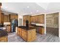 Spacious kitchen with wood cabinets, a center island with granite countertop, and stainless steel appliances at 4139 Bayberry Ct, Greenwood, IN 46143