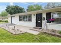 Inviting front porch with brick accent and black door, enhancing the home's curb appeal at 4482 Priscilla Ave, Indianapolis, IN 46226