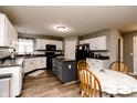 Bright kitchen featuring white cabinets, a central island, and modern appliances at 450 Columbia Ct, Greenwood, IN 46142