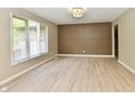 Light-filled living room showcasing wood-look floors, decorative wall, and neutral color scheme at 504 W Gold Creek Rd, Mooresville, IN 46158