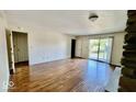 Spacious living room boasting hardwood floors and sliding glass doors to a private balcony at 5222 Nob Ln, Indianapolis, IN 46226