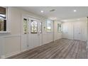 Inviting entryway with decorative glass door and windows, featuring recessed lighting and light wood flooring at 6348 W 750 N, McCordsville, IN 46055
