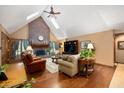 Cozy living room with a fireplace, hardwood floors, and vaulted ceilings at 6575 Robin Hood Dr, Indianapolis, IN 46227