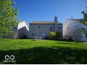 Spacious backyard featuring a well-kept lawn, patio area, and surrounded by neighboring houses and a privacy fence at 6604 Heritage Hill Dr, Indianapolis, IN 46237