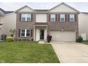 Charming two-story brick home featuring a two-car garage and well-maintained front lawn at 6604 Heritage Hill Dr, Indianapolis, IN 46237