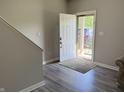 Bright foyer with hardwood floors and an open view to the outdoors through the front door at 6604 Heritage Hill Dr, Indianapolis, IN 46237